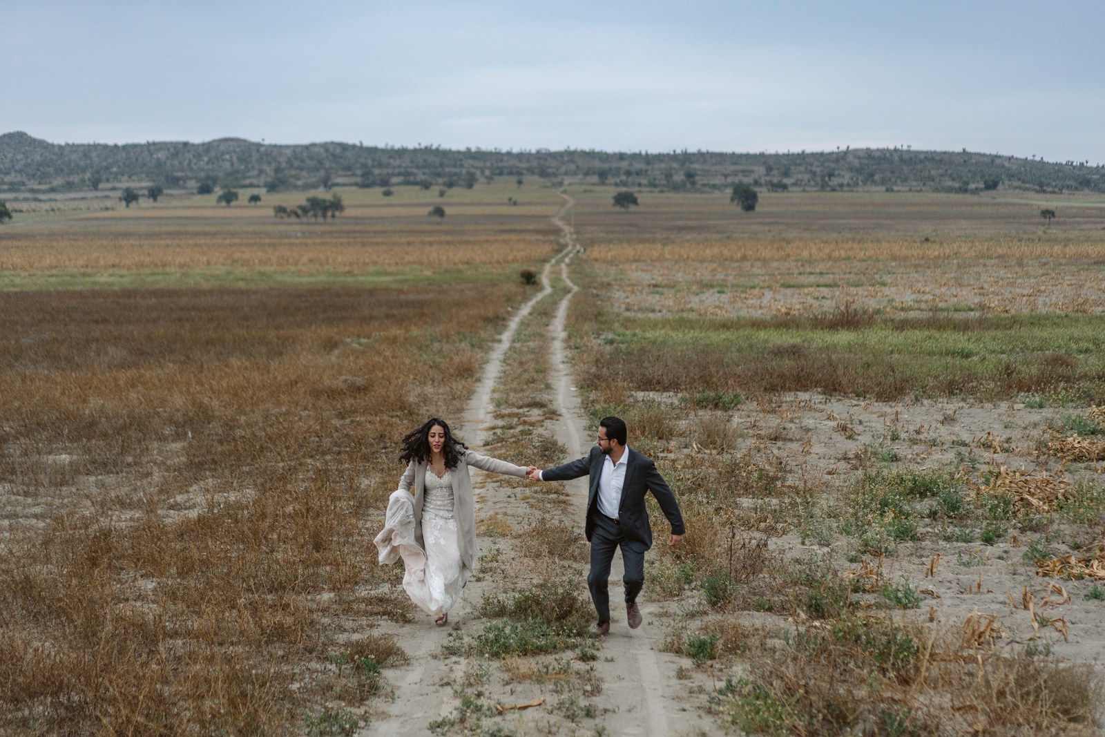 Luis and Emelia walking together along a road